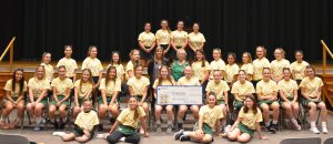 members of the jv and varsity field hockey teams from Weedsport pose with a check. 