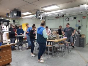 A group of students work on a project in the school's wood shop