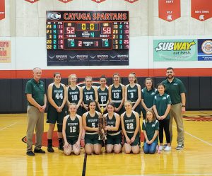 The girls basketball team poses with a tournament trophy