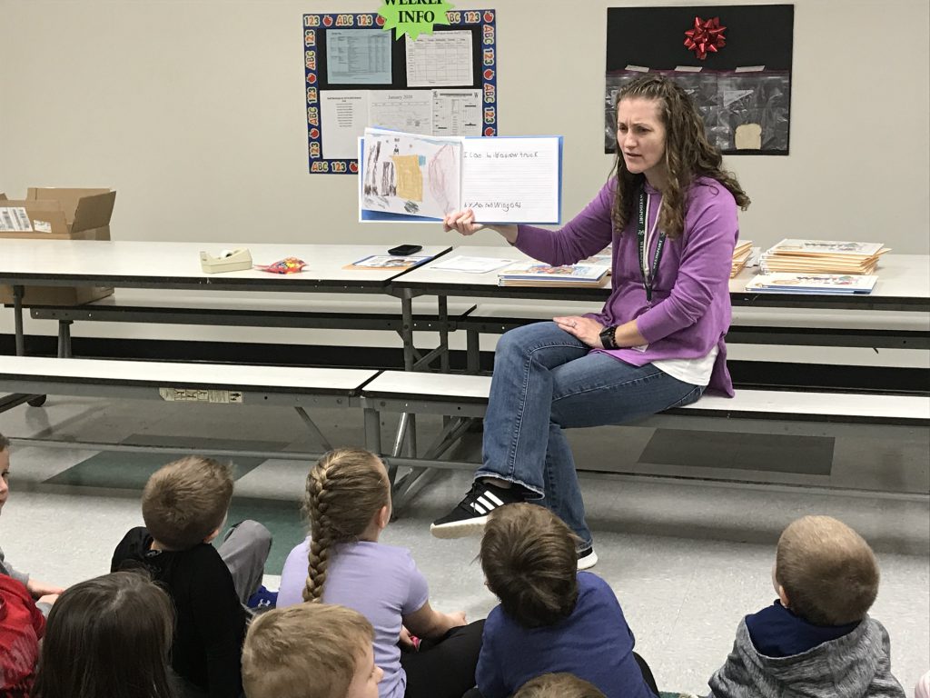 The librarian reads to a group of elementary students. 