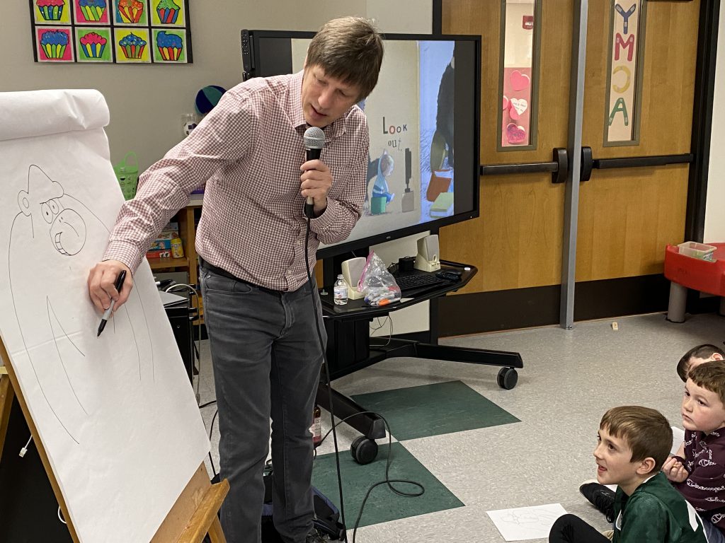 Author Jeff Mack draws a picture and talks to students 