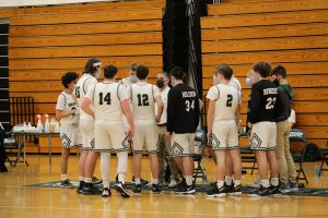 Boys Varsity Basketball Team comes together for a huddle