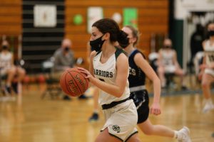 2021 senior Suzie Nemec dribbles the ball during a basketball game