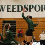 Trinity Davis spikes the ball over the net