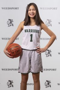 2021 Mia Ada poses for Weedsport Varsity Basketball team photo