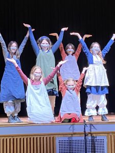 Students in grades 5-8 rehearse ahead of the opening night of Annie, Jr.