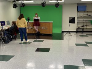 Students film a video introduction in journalism class