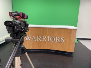 Warrior TV anchor desk setup in the Weedsport HS media lab
