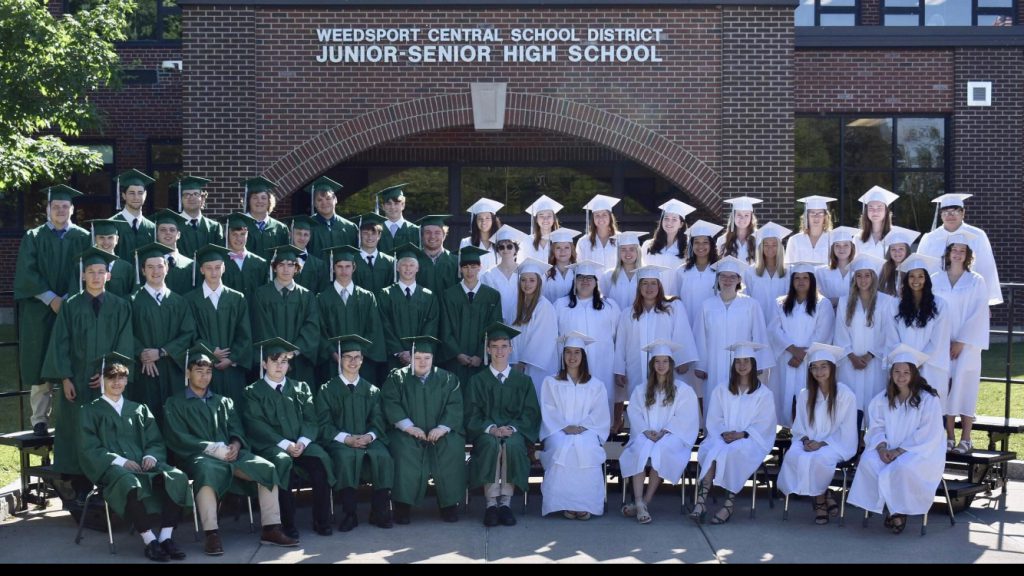 The Class of 2022 poses for a group photo in front of the Jr.-Sr. High School