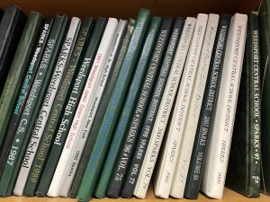 Past Weedsport SPARKS yearbooks line a shelf