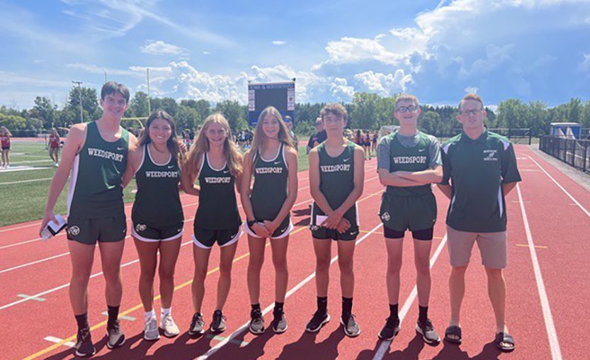 Weedsport cross country teammates pose for a photo at media day