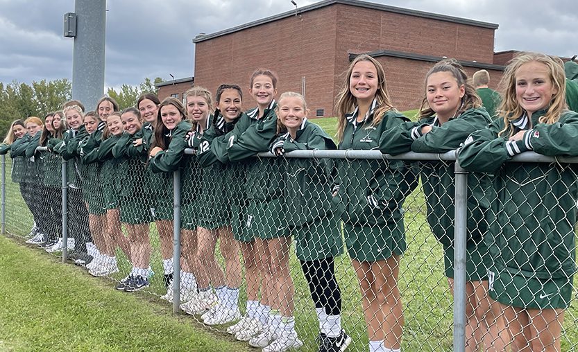 Field Hockey players line the fence to watch the 2022 pep rally