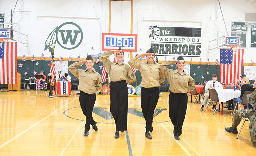 Four high school students perform a tap dance routine during the 2022 USO show.