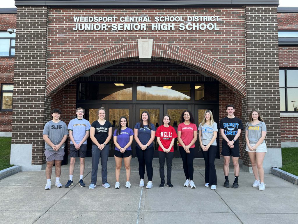 The top ten students of the Class of 2023 pose for a photo in front of the Jr.-Sr. High School