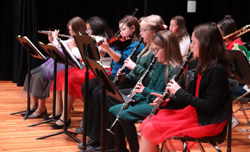 Band students playing instruments at concert