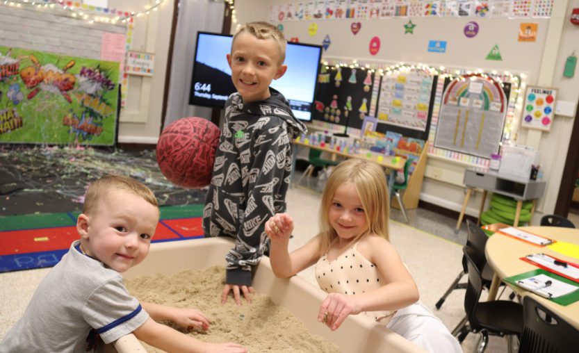 Students working together at sand table