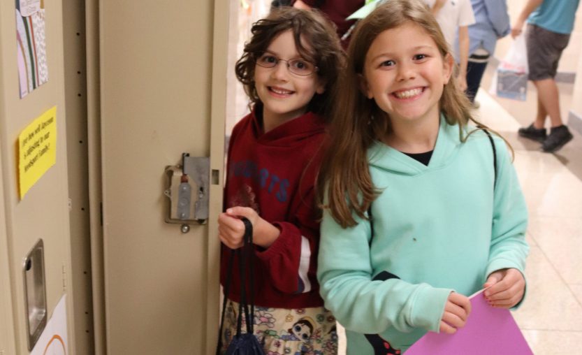 Students helping each other at locker