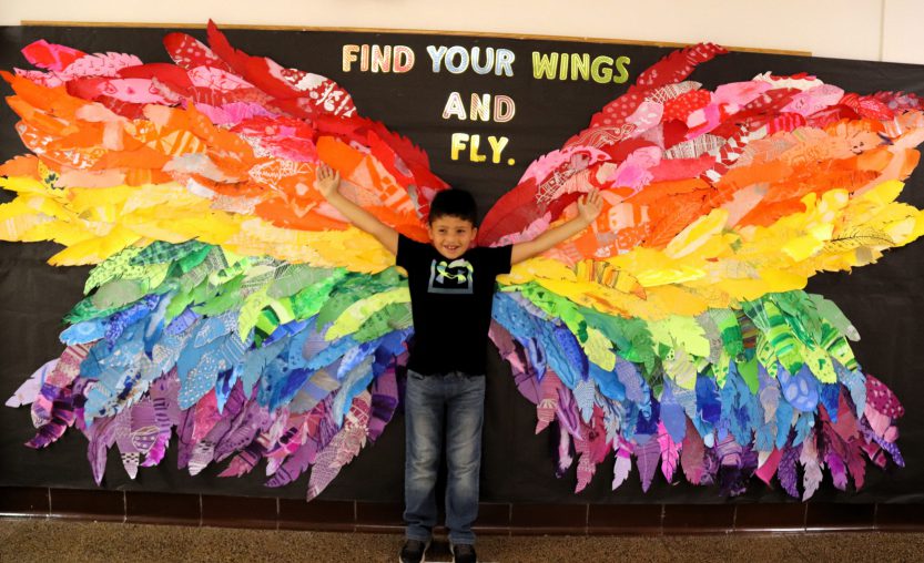 Image of student in front of wings